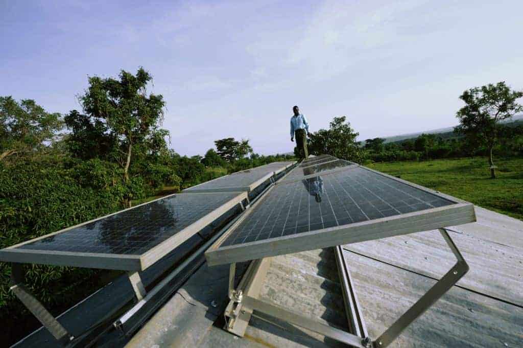 Man On a roof of the Senator Obama Secondary School ,Kogelo Village ,Siaya District Kenya The school was given 10 Solar Panels in August of 2009 by Green Peace in conjunction of the Solar Generation Of Kenya , with these Solar panels , can power ten computers during school hours, which are between 8 A.M. to 17:oo