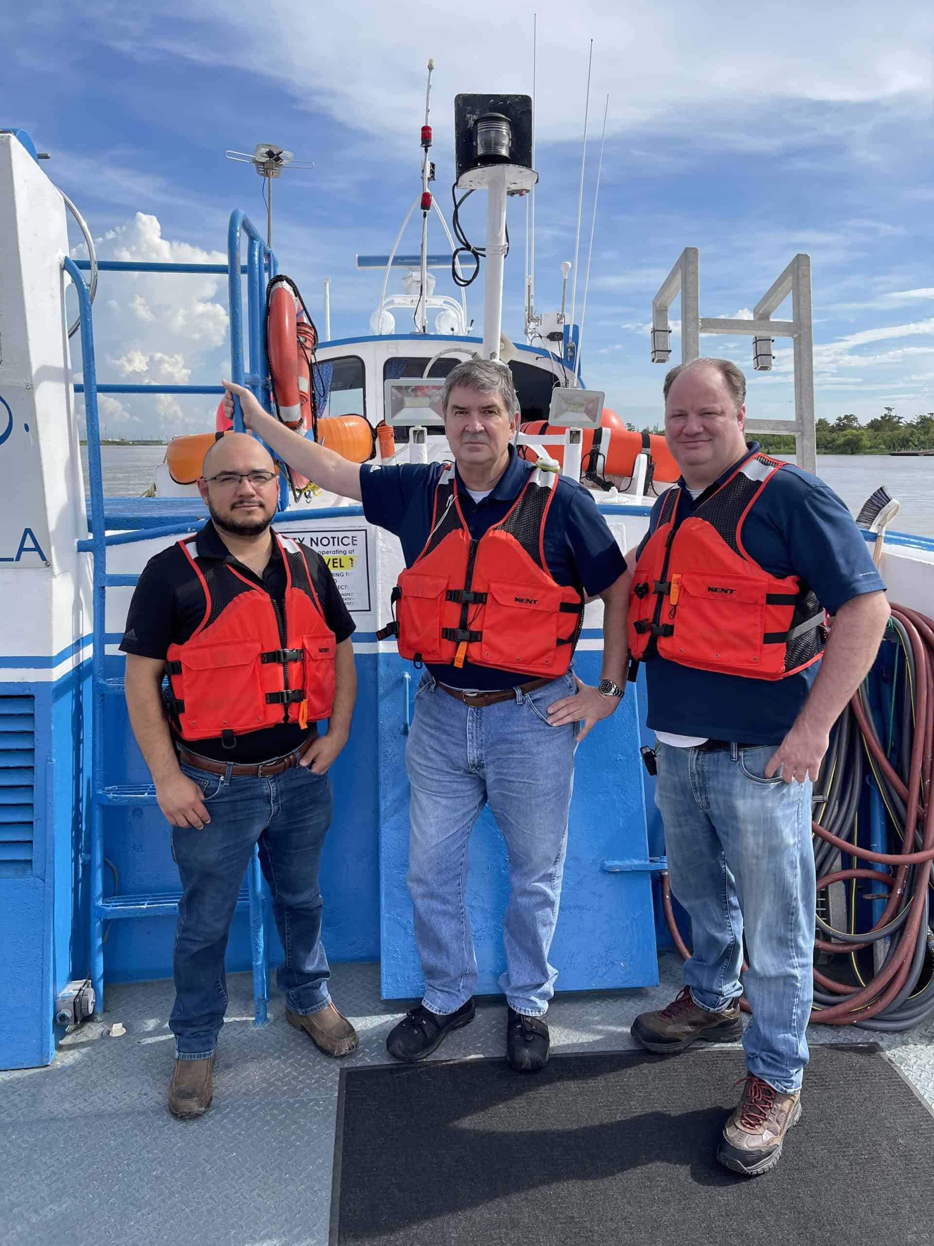 Felix Gonzalez, John, Janik, and Charles Sutherland visiting dredge site to provide electrical service